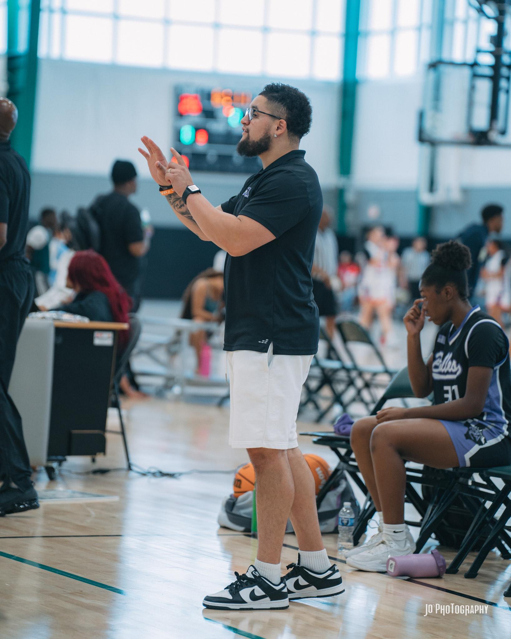 Coach clapping encouragement on the sideline