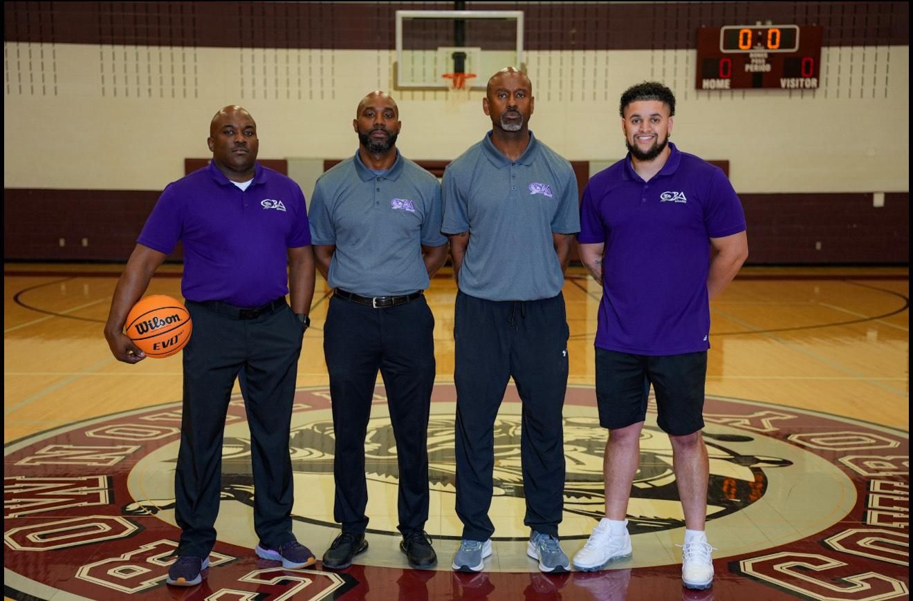 Coaches celebrating with championship trophy